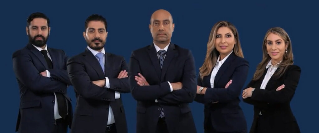 The five partners of Black Diamond Law standing together in dark suits outside the firm's Los Angeles office