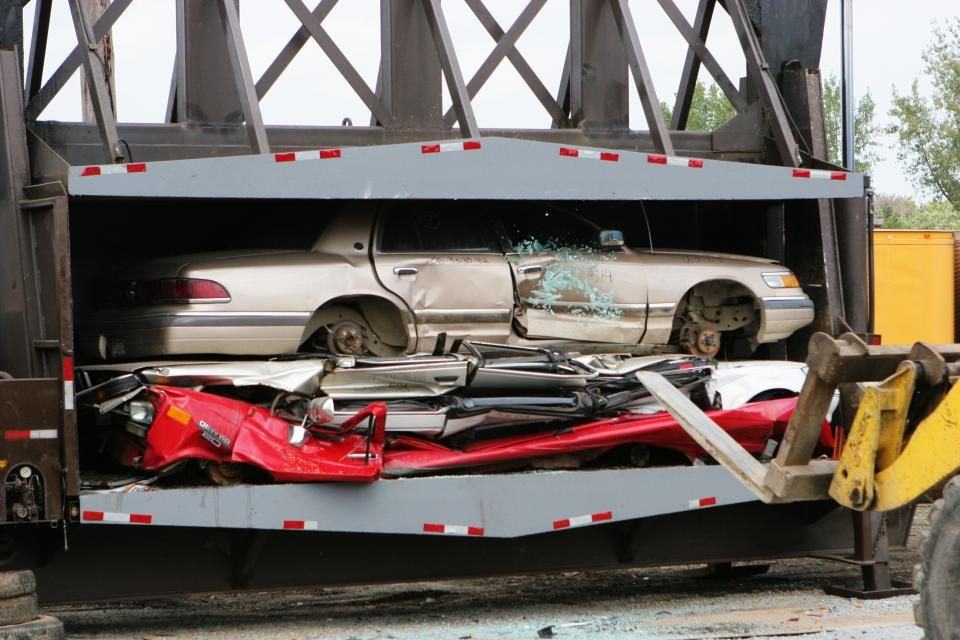 Severely damaged car being towed after a high-impact collision, representing serious auto accident claims