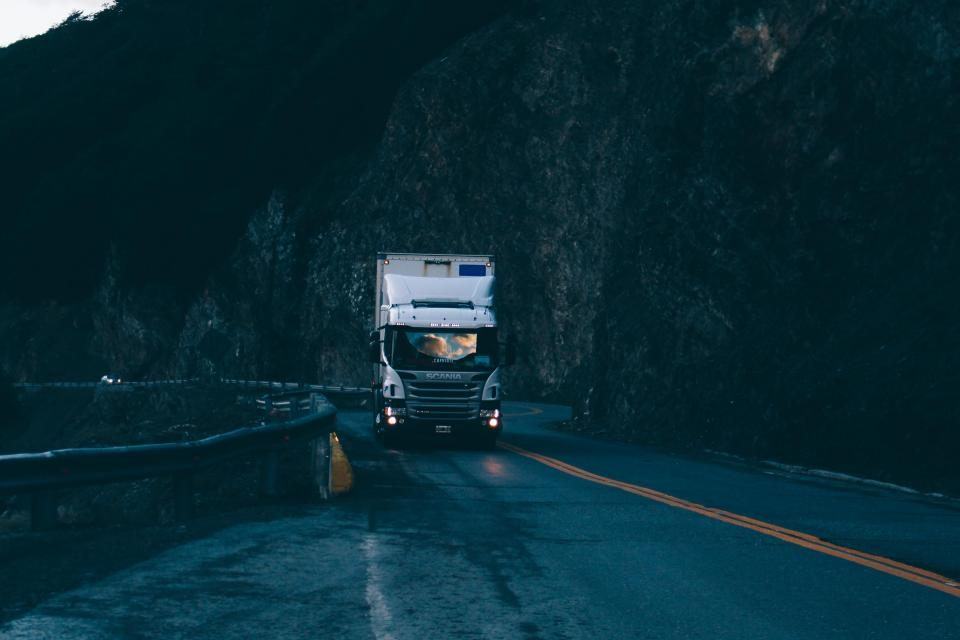 Commercial semi truck on a highway at dusk, representing trucking accident litigation against carriers and insurers